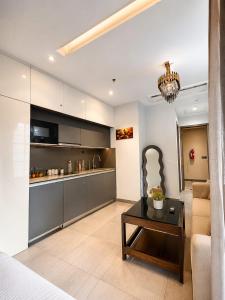 a living room with a couch and a table at Skyvera Stay at Supernova Spira in New Delhi