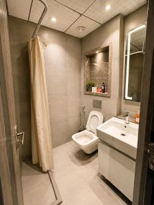 a bathroom with a toilet and a sink at Skyvera Stay at Supernova Spira in New Delhi