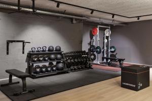 a gym with dumbbells and weights in a room at Linde Villas in Maria Wörth +52 photos