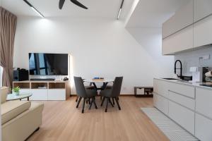 a kitchen and living room with a table and chairs at Space Residency 2 bedroom 2 bathroom B59-11 in Johor Bahru