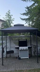 a gazebo with a stove and a grill at Cudowne poddasze in Piotrków Trybunalski +3 photos