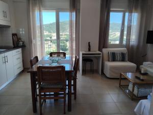 a kitchen and living room with a table and chairs at EFThea Valley in Skála Sikiás