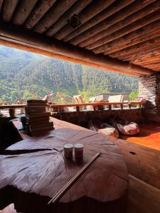a table with books and chopsticks on top at Firefly in Shatili