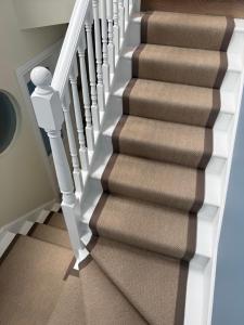 a stairwell with a carpeted staircase with white railings at The Nook County Dublin in Dublin