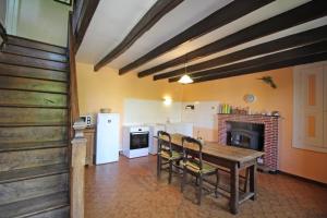 a kitchen with a table and chairs in a room at Boissac in Le Vigen