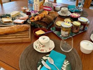 a table topped with bread and pastries on a table at La Salamandre 66 in Saint-Génis