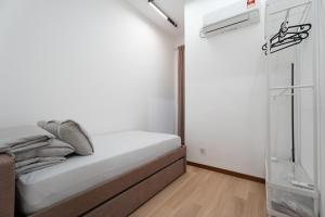 a small bedroom with a bed and a window at Space Residency 2 bedroom 2 bathroom B59-11 in Johor Bahru +12 photos