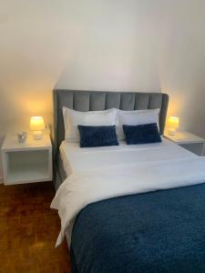 a bedroom with a large bed with two night stands at AP Museu Maputo in Maputo