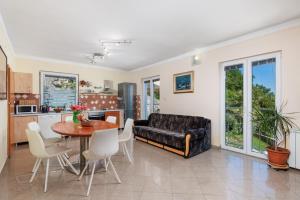 a living room with a table and a couch at Apartments Bellavista in Matulji