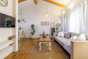 a living room with a couch and a coffee table at The White Chalet Boutique in Moshav Ramot