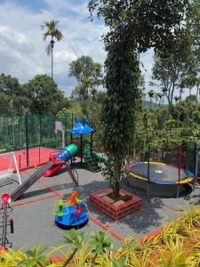 a playground with several slides and a play equipment at Wild Nest Resort, Wayanad in Meppādi