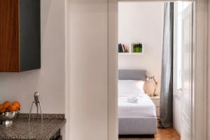 a bedroom with a bed and a table with oranges at Vittorio Emanuele Apartment - Downtown Como in Como