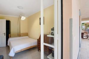a bedroom with a bed and a room with a table at Villa Roberta Pool, wifi & Parking in Arenzano +26 photos