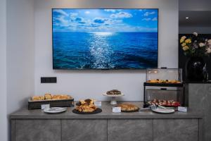 a buffet with a large picture of the ocean at Olympus Jankaea in Paralia Katerinis