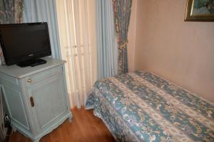 a bedroom with a bed and a television at Grand Hotel Bristol in Stresa