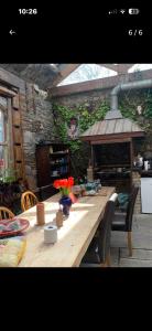 a wooden table with flowers on top of a patio at The Last Post in Wexford