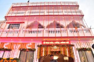 a man standing in front of a building at Shree Videhi Atithi Grah in Ayodhya
