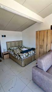 a room with two beds and a couch in it at Kotor Bay View Apartments in Bijela +67 photos