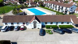 an aerial view of a house with cars parked in a parking lot at Sea & Stay Bredene Zeewind 2 in Bredene