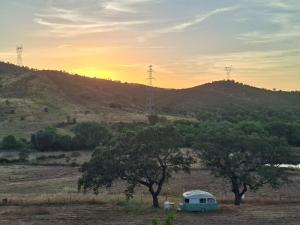 a camper van parked in a field with trees at Lost Paradise - Cosy Wagon in Sabóia