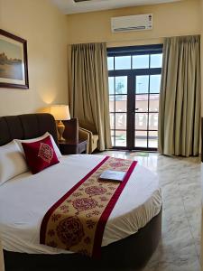a hotel room with a bed and a window at Shree Videhi Atithi Grah in Ayodhya