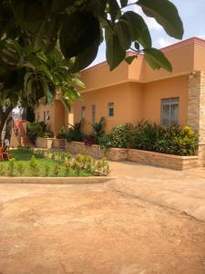 a building with a lot of plants in front of it at Makindye Orange House in Kampala