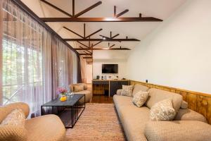 a living room with two couches and a table at DiliJazz Hotel & Restaurant in Dilijan
