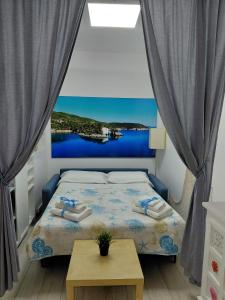 a bedroom with a bed with a view of the water at CASA VACANZE NANA' VIESTE in Vieste