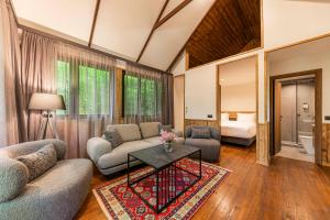 a living room with a couch and a table at DiliJazz Hotel & Restaurant in Dilijan