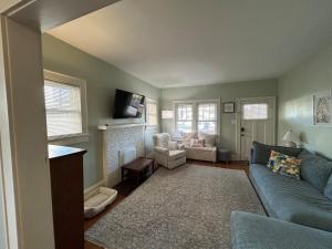 a living room with a blue couch and a fireplace at Tranquility Corner in Ashland