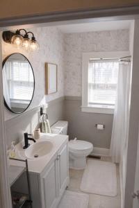 a bathroom with a sink and a toilet and a mirror at Tranquility Corner in Ashland +39 photos
