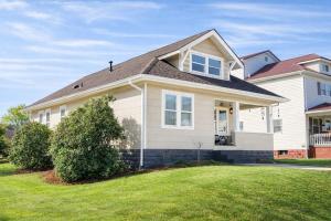 a white house with a large grass yard at Tranquility Corner in Ashland