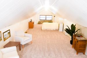 a attic room with a bed and a chair at Tranquility Corner in Ashland