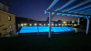 a swimming pool at night with a pergola at Villa Malvasio - Piscina & Suite Idromassaggio in Sassari +61 photos