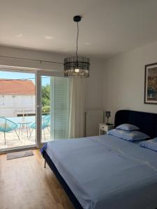 a bedroom with a bed and a view of a patio at Zimmer Room Trogir Kastela Split in Kaštela +38 photos