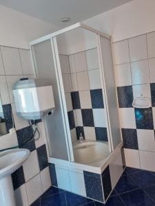 a bathroom with a shower with a toilet and a sink at Kłączyn in Kłaczno