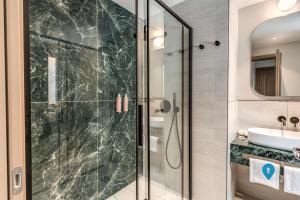 a bathroom with a shower and a sink at TriplyRooms Collection - Roma Prassede in Rome