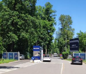 a street with cars driving down a road with trees at Pop Up Village in Villasanta