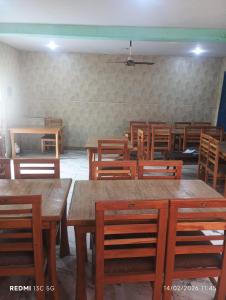 a dining room with wooden tables and wooden chairs at New shalimar dal view in Srinagar