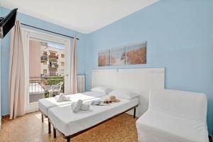 a living room with two beds and a window at Hotel Del Golfo in Laigueglia