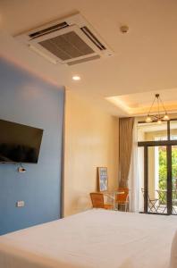 a bedroom with a bed and a living room at An190 Boutique Hotel in Bangkok