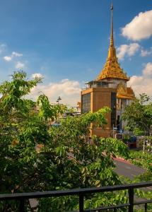 a building with a gold steeple in a city at An190 Boutique Hotel in Bangkok