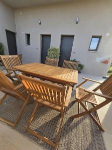 a wooden picnic table and chairs on a patio at Chambre indépendante vue vignes et mer in Saint-Cyr-sur-Mer