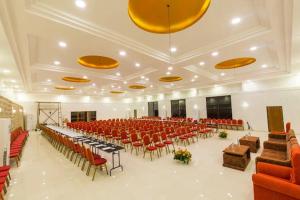 a large banquet hall with red chairs and tables at DANFÉ Lodge Halesi in Lamidanda