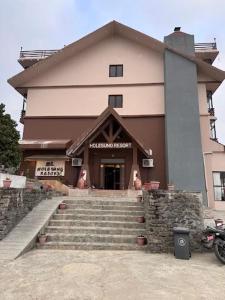 a building with stairs in front of a building at DANFÉ Lodge Halesi in Lamidanda
