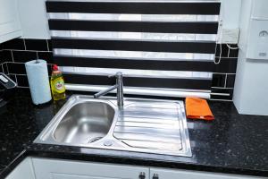 a kitchen counter with a sink and a window at Onyx Place Spacious 3BR Home l Fast London Commute l Parking in North Ockendon +18 photos