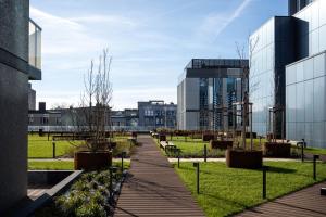 a walkway in front of a building with buildings at Sky tower space in Katowice