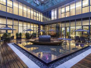 a lobby with a boat in the middle of a building at Mercure Kunshan Hi Tech Zone in Kunshan
