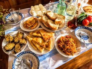 a table with plates of food on a table at Sarag Family Guesthouse Svaneti in Mestia
