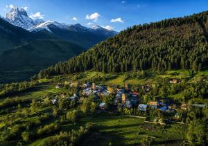 an aerial view of a village in a mountain valley at Sarag Family Guesthouse Svaneti in Mestia